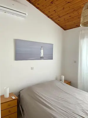 a bedroom with a bed and a lighthouse on the wall at The Mediterranean Sea at your doorstep!! in Meneou