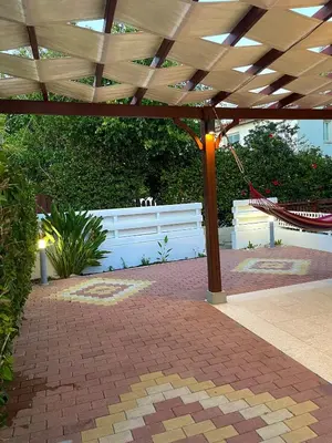 a pavilion with a hammock and a white fence at The Mediterranean Sea at your doorstep!! in Meneou