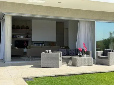 a living room with wicker couches and a living room at Luxury Villa Pluto Stunning Mountain Views in Ora