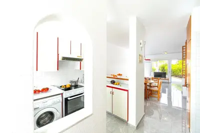 a kitchen with a washer and dryer and a dining room at Maistralli Villa in Protaras