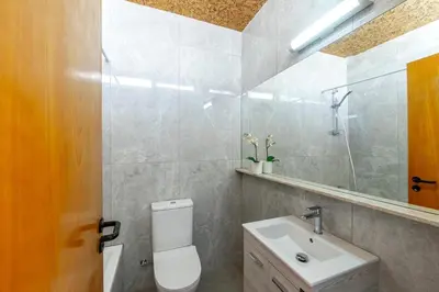 a bathroom with a toilet and a sink and a mirror at Maistralli Villa in Protaras