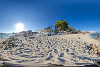 a beach with a lot of sand and the ocean at Nissi 3 Amazing Sea View Apartment in Ayia Napa