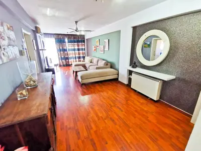 a living room with a couch and a mirror at Sun Kissed Apartment in Larnaka