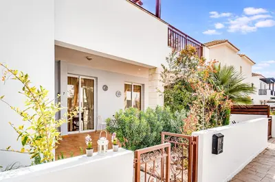 a white house with a white fence and plants at Villa Rosedale by Ezoria Villas in Ayia Napa