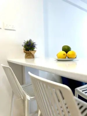 a table with a plate of fruit on a table at Serene Napa Suites - Heart of Ayia Napa in Ayia Napa