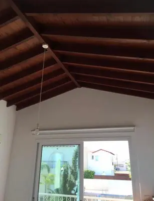 a room with a window and a wooden ceiling at Villa millie Cyprus in Protaras
