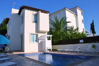 a villa with a swimming pool in front of a house at Villa millie Cyprus in Protaras