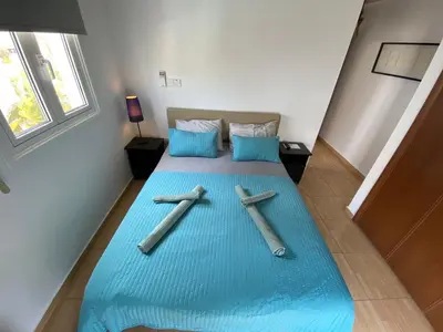 a large blue bed with three crosses on it at Villa Diana - 200 meters from Kapparis, Fireman's Beach in Paralimni