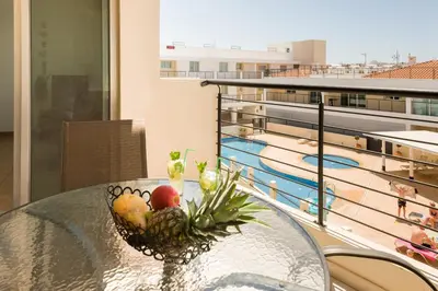a bowl of fruit on a table next to a pool at SEABREEZE APARTMENT 200m away from the sea in Paralimni
