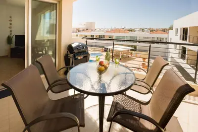 a table and chairs on a balcony with a view at SEABREEZE APARTMENT 200m away from the sea in Paralimni