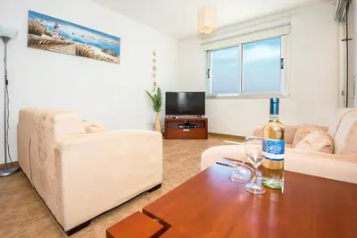 a living room with a bottle of wine on a table at SEABREEZE APARTMENT 200m away from the sea in Paralimni