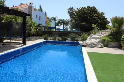 a swimming pool in the yard of a house at Immaculate 3-Bed House in Pentakomo in Pendakomo