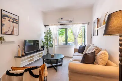 a living room with a couch and a tv at Arty Haven - Spacious 3-BR House in Larnaca in Larnaka