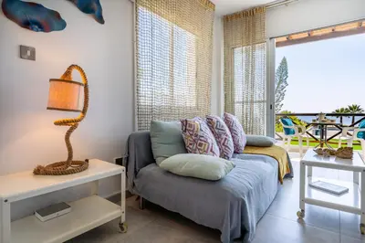 a living room with a couch and a table at Seawaves 1- Bedroom Apartment near Meneou Beach in Larnaka