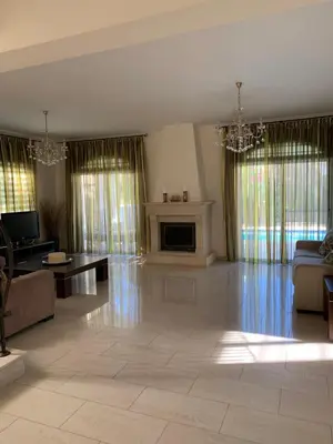 a large living room with a couch and a fireplace at Villa in Protaras in Protaras