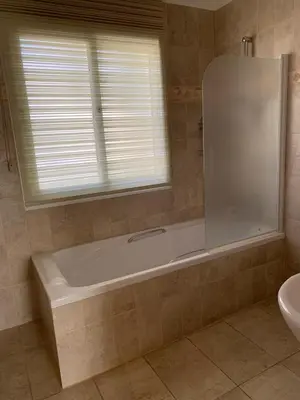 a bathroom with a tub and a sink and a window at Villa in Protaras in Protaras