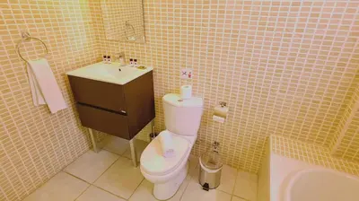 a bathroom with a toilet and a sink at Nissi 3 Privileges Apt in Ayia Napa