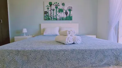 a bedroom with a bed with towels on it at Nissi 3 Privileges Apt in Ayia Napa