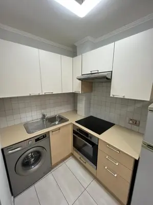 a kitchen with a washing machine and a sink at Dene Hollow Ayia Napa in Ayia Napa