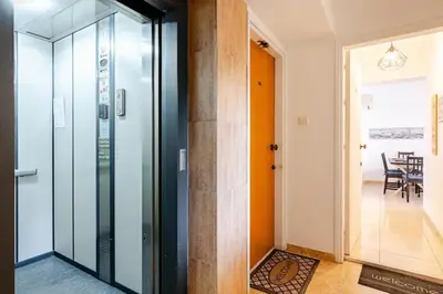 a hallway with a glass door leading to a dining room at Carisa DownTown with Rooftop pool in Larnaka