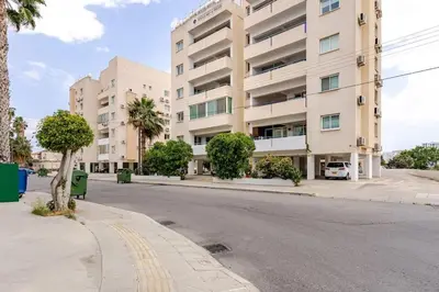 an empty street in front of a large building at Carisa DownTown with Rooftop pool in Larnaka