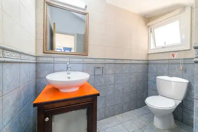 a bathroom with a sink and a toilet at Villa Serena Springs by Ezoria Villas in Protaras
