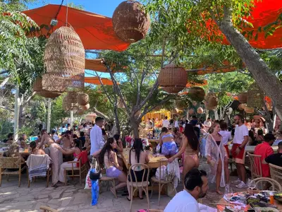 a crowd of people sitting at tables at a party at Villa Serena Springs by Ezoria Villas in Protaras