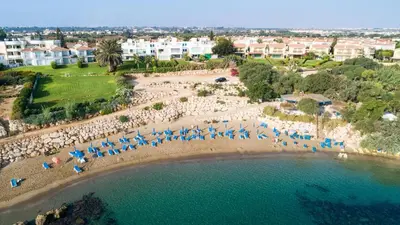 an aerial view of a beach with chairs and umbrellas at Villa Serena Springs by Ezoria Villas in Protaras