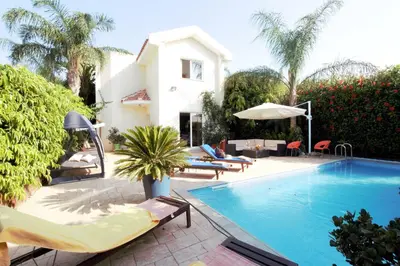 a villa with a swimming pool and a house at Helene Villa in Protaras