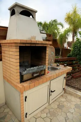 a outdoor kitchen with a brick oven and a sink at Artemisia Villa in Protaras