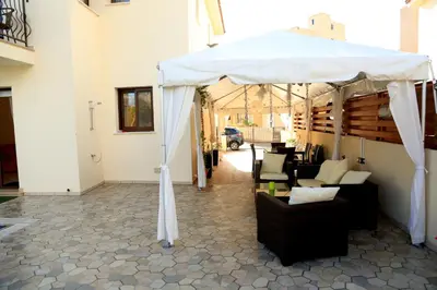 a white tent with couches and chairs under it at Artemisia Villa in Protaras