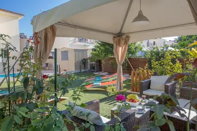 a patio with a table and chairs under a canopy at Antonia Villa in Protaras
