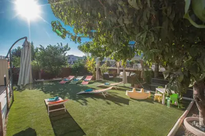 a backyard with a bunch of chairs and a tree at Antonia Villa in Protaras