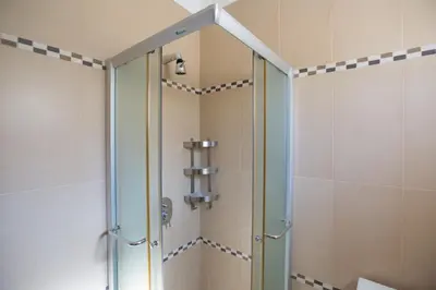 a shower with a glass door in a bathroom at Antonia Villa in Protaras