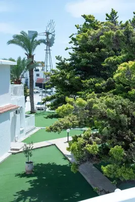 an image of a yard with trees and a windmill at Flisvos Beach Apartments in Protaras