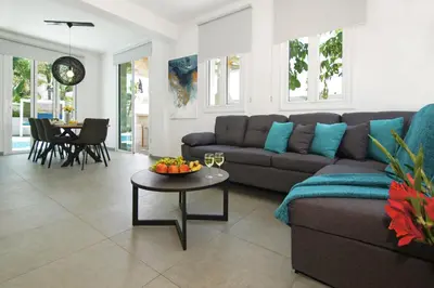 a living room with a couch and a table at Villa Blue Oasis in Protaras