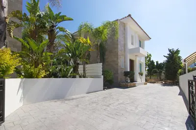 a courtyard of a house with trees and plants at Villa Blue Oasis in Protaras