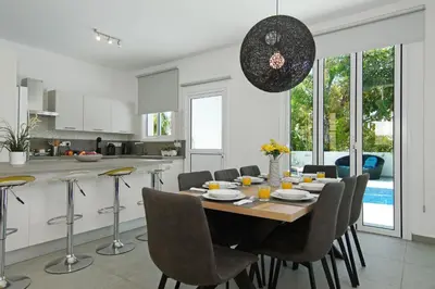 a kitchen and dining room with a table and chairs at Villa Blue Oasis in Protaras