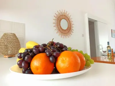 a bowl of fruit on a counter in a kitchen at The Salnik Beach Apartment in Limassol