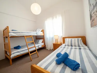 a bedroom with two beds and a bunk bed at The Salnik Beach Apartment in Limassol