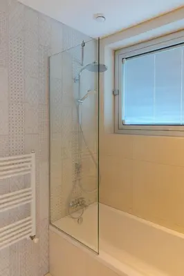 a glass shower in a bathroom with a window at Love Bridge Seaview Villas in Ayia Napa