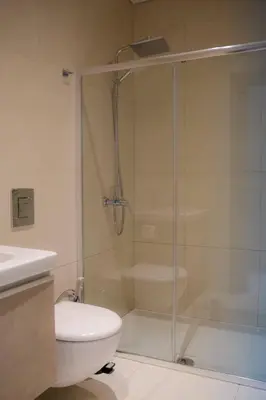 a bathroom with a shower and a toilet and a sink at Love Bridge Seaview Villas in Ayia Napa