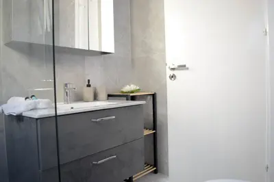 a bathroom with a sink and a mirror at Coastal Getaway in Larnaka