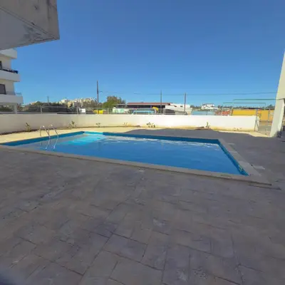 a swimming pool in the middle of a patio at Coastal Getaway in Larnaka
