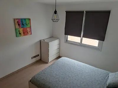 a bedroom with a bed and a window and a dresser at Modern Suite, XL balcony, parking in Nicosia