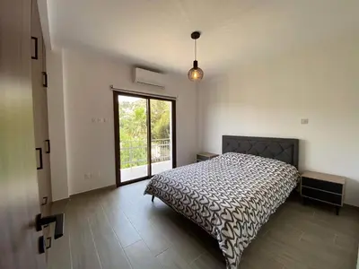 a bedroom with a bed and a large window at Maria's Apartments 1 in Galata