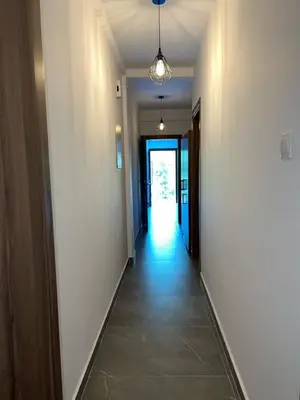 an empty hallway with a hallway leading to a door at Maria's Apartments 1 in Galata