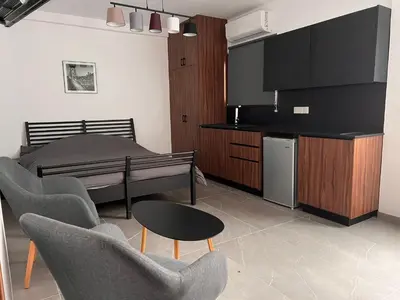 a living room with a bed and a table and chairs at Maria's Apartment 2 in Galata
