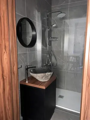 a bathroom with a sink and a shower at Maria's Apartment 2 in Galata