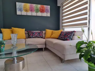 a living room with a couch and a glass table at Ikaros Boutique Apartment in Limassol